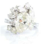 A diamond dress ring, the principal pear cut diamond measuring approx. 3.57ct, surrounded by three