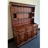 A Titchmarsh and Goodwin solid oak three door dresser.