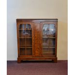 A walnut glazed two door bookcase.