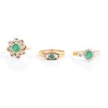 Three hallmarked 9ct yellow gold rings, to include an emerald and diamond cluster, a three stone