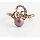 An Art Nouveau style pearl and diamond ring, set with a pinkish purple button pearl, measuring