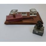 A mahogany based inkwell stand with a blotter and a metal figure of Napoleon on marble base