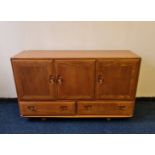 An Ercol elm sideboard with two drawers. BOOK A VIEWING TIME SLOT ON OUR WEBSITE FOR THIS LOT.