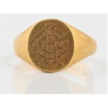 A hallmarked 18ct yellow gold signet ring, the oval head engraved with monogram, ring size S. BOOK A