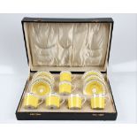 A Crescent six cup and saucer set, yellow and gold on white background in black box. BOOK A