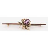 A purple paste and seed pearl insect bar brooch, set with oval cut purple paste to body and seed