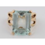 A hallmarked 9ct yellow gold aquamarine dress ring, set with an emerald cut aquamarine, measuring