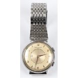 A gents Jaeger Le Coultre wrist watch, the champagne dial having alternate Arabic numerals and arrow