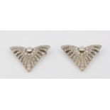 A pair of Art Deco style diamond set brooches, each of open metalwork triangular design set with a