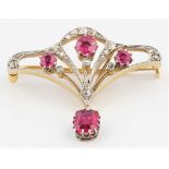 An Edwardian synthetic ruby and diamond brooch, set with three round cut synthetic rubies surrounded