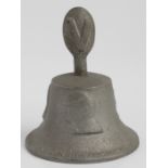 A round bell topped with “V” for victory sign made of metal from a German aircraft shot down over