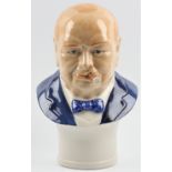 A Sir Winston Churchill Millienium Bust, depicting him with a cigar and blue suit and bow tie,