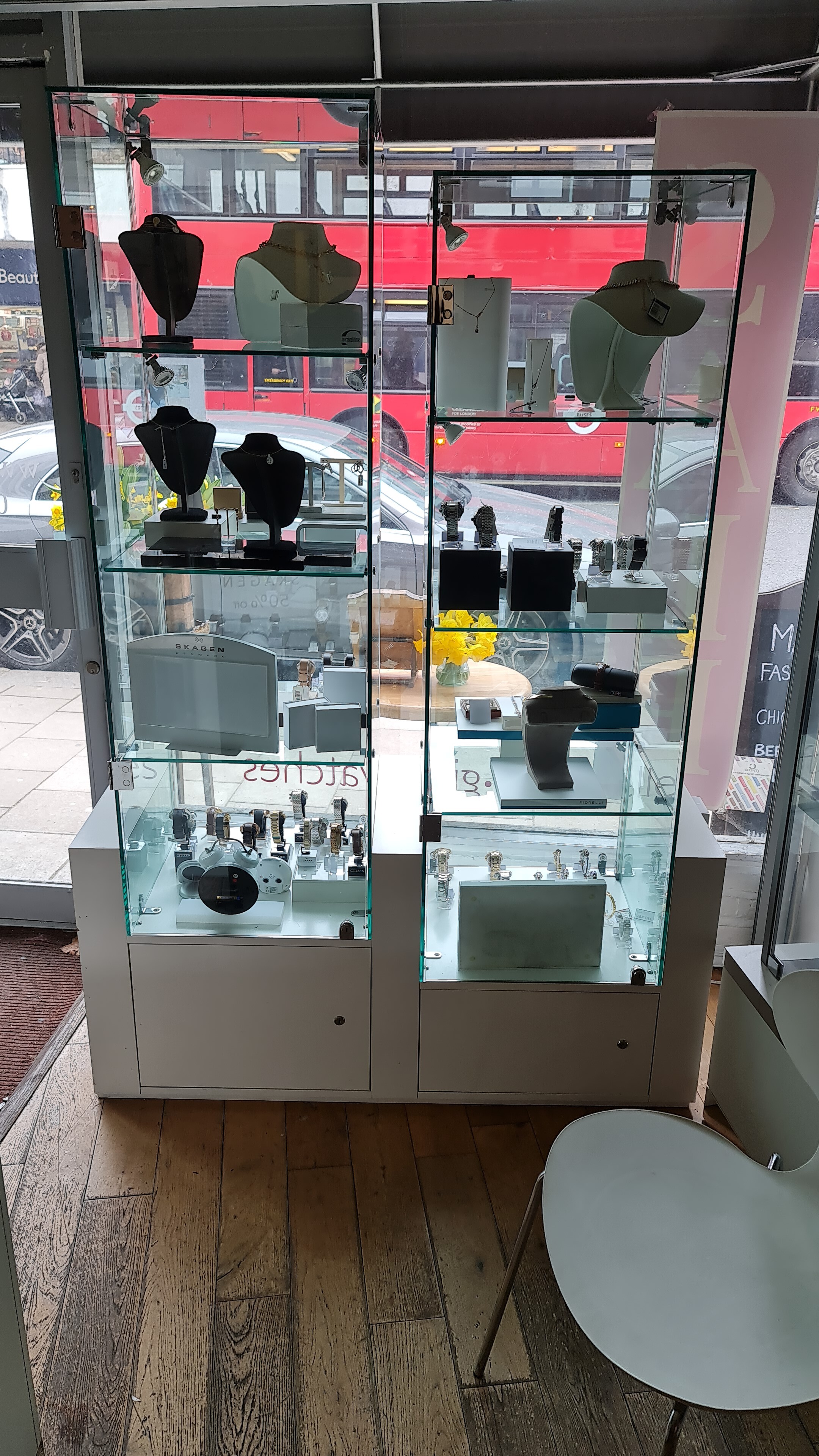 A shop display unit with two glazed door sections with locks and internal glass shelves on storage