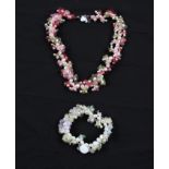 A string of cultured pearls with fabric floral cut-outs, clasp stamped 925, together with an