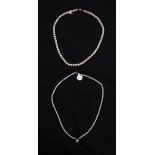 A string of cultured pearls with pear shaped pearl dropper, clasp stamped 585, length approx. 16",