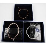 SWAROVSKI. Three Swarovski necklets of differing designs, all boxed. 5392925, 5367845, 5117703. BOOK