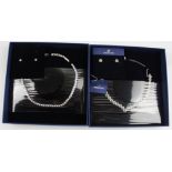 SWAROVSKI. Two Swarovski necklet and earring sets, both boxed. 5007747, 5364318. BOOK A VIEWING TIME