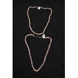 Two strings of purplish pink cultured pearls, both clasps stamped 925, lengths approx. 18". BOOK A