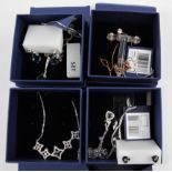 SWAROVSKI. Four Swarovski necklace and earring sets of various designs, all boxed. 5408433, 5299319,