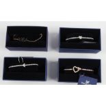 SWAROVSKI. Four Swarovski bracelets/bangles of various designs, all boxed. 5368541, 5349630,