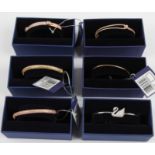 SWAROVSKI. Six Swarovski bracelets/bangles of various designs, all boxed. 5032850, 5032848, 5152481,