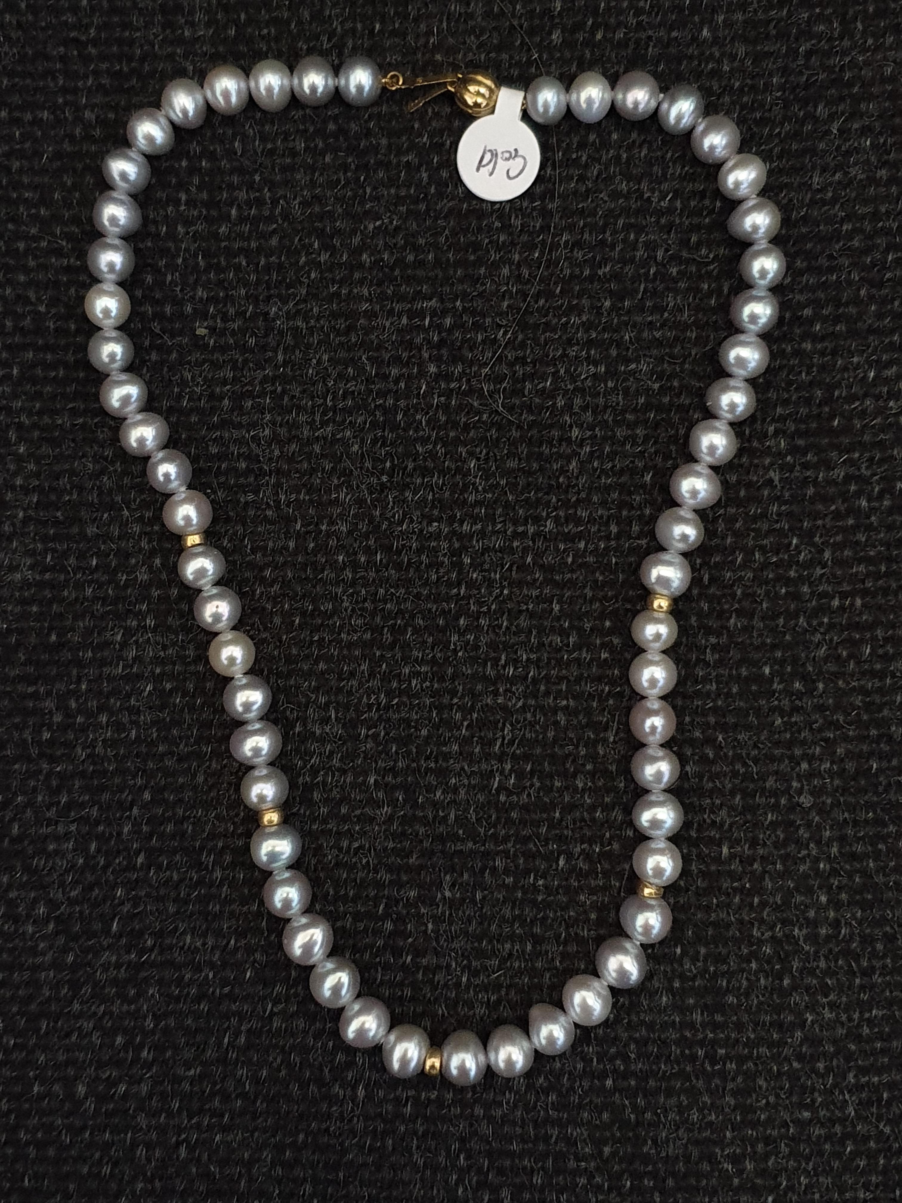 A string of grey cultured pearls, with gold-tone spacers, clasp stamped 375, length approx. 15".