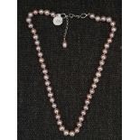 A string of purplish pink cultured pearls, clasps stamped 925, lengths approx. 18". IMPORTANT: