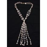 A triple strand of cultured pearls in gathered design, comprising spherical, oval and baroque