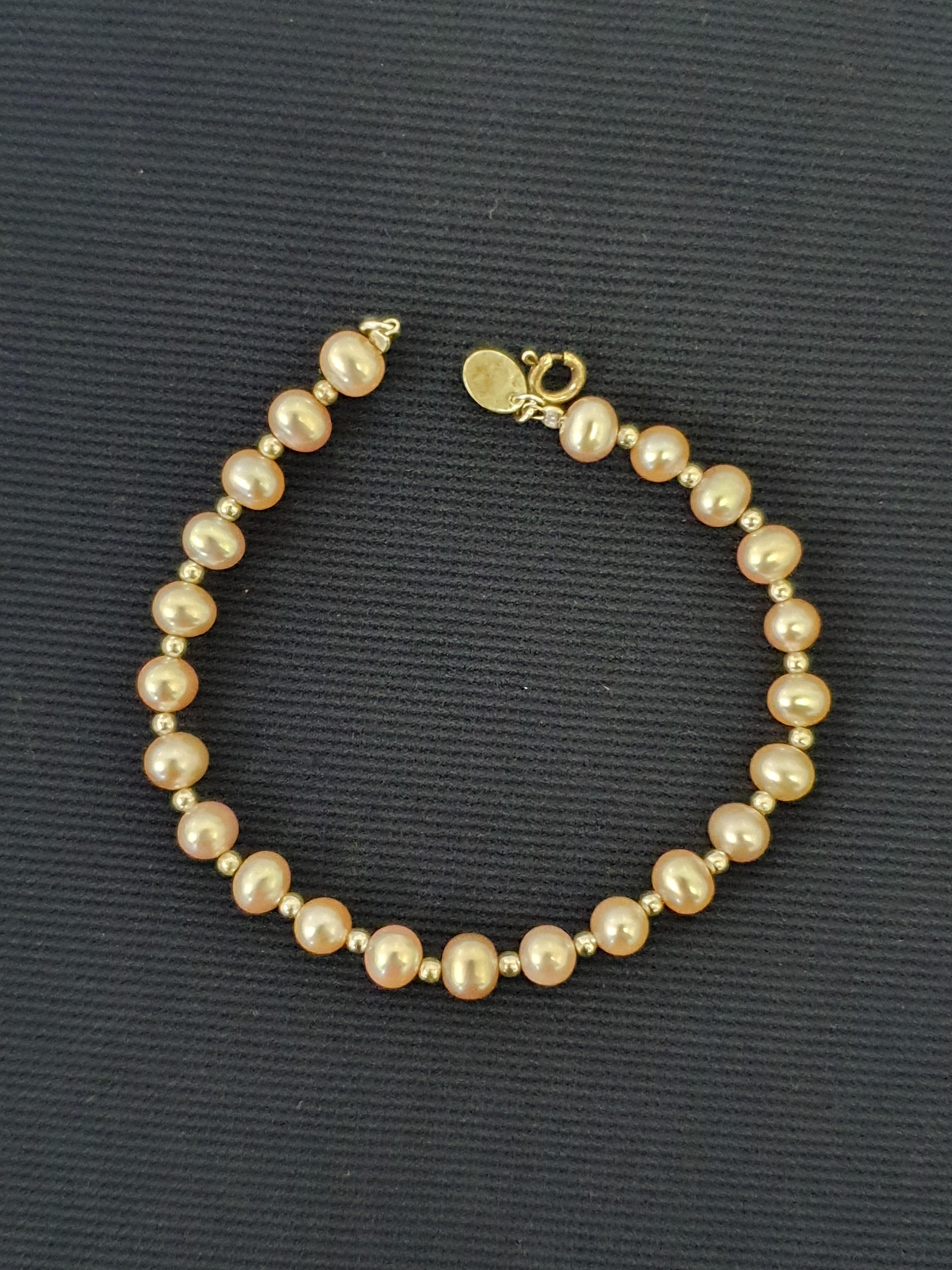 A pinkish purple cultured pearl bracelet with silver-tone spacers, stamped 925. IMPORTANT: Bidding