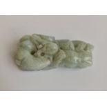 A green jade pendant with a dragon. Approx length 6cm.