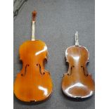 Two Cellos with broken necks, one with neck included, other with split neck still present, with