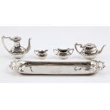 A hallmarked silver miniature tea set, comprising of a teapot, coffee pot, milk jug and sugar bowl