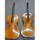 Two Cellos, with carrying bags, stringless and with split and superficial damage to front and back.