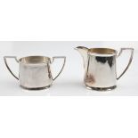 A silver plated Walker & Hall milk jug and sugar bowl, both having geometric design handles.