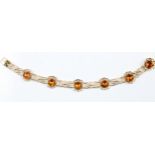 A hallmarked 9ct yellow gold citrine bracelet, set with six round cut citrines in open metalwork