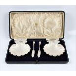 A pair of boxed Elkington silver glass lined shell butter dishes and butter knives, hallmarked