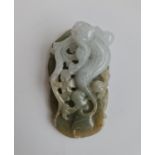 A jade green to pale green pendant with a dragon on foliage. Approx length 6cm.