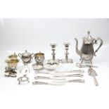 A collection of EPNS to include a 3 piece tea set, pair of candle sticks, pair of grape scissors,