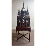 A reproduction mahogany Victorian style bird cage on table base in the form of gothic style