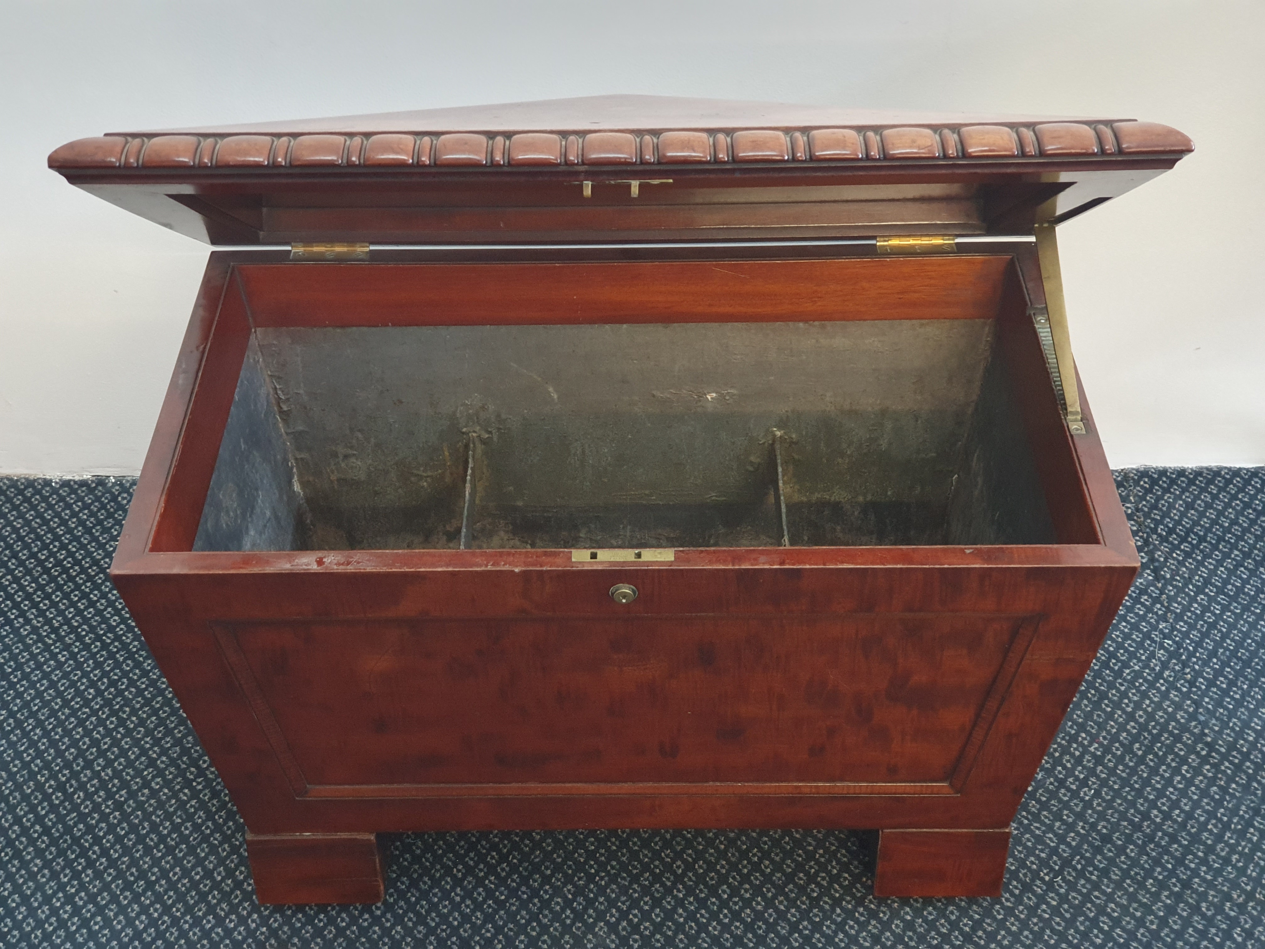 A 19th century mahogany sarcophagus shaped led lined wine cooler with hooped handles to side.