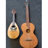 A Bowlback mandolin with butterfly design to front together with classical guitar with crack to back
