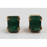 A pair of emerald earrings, each set with an emerald cut emerald measuring approx. 7x6mm, in