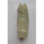 A pale green jade carving of a bamboo shoot with tree blossom. Approx length 7.5cm.