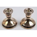 A pair of hallmarked silver weighted candlesticks, approx.height 7.5cm.