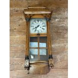 An oak cased wall clock.