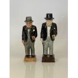 Two standing figures of Winston Churchill approx. 19cm in height on a brown base.