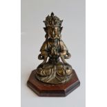 An 18th Century Chinese bronze figure of a Deity seated on wooden base.( Sold at Mallams 20-1-