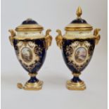 A pair of Coalport blue and cream urns with lids ( damaged).