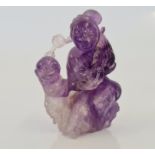 A Chinese amethyst hardstone carved figure of Goddess and child.