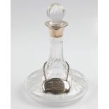 A hallmarked silver collared glass decanter with silver plated decanter label.